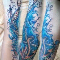 Awesome half nautical colored DNA in water with anchor tattoo on sleeve