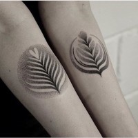 Awesome little black ink dot style forearm tattoo of various leaves