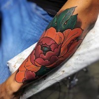 Awesome natural colored big forearm tattoo of flower with leaves