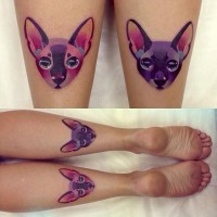 Tatuaje en las piernas,
 dos gatos idénticos de color púrpura