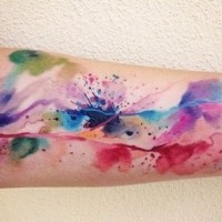 Awesome watercolor color abstraction forearm tattoo