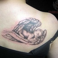 Baby cherub asleep on wing tattoo on shoulder blade