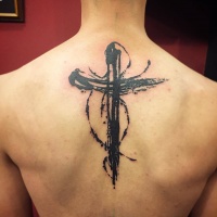 Beautiful black cross tattoo on back