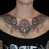 Beautiful black lace chest tattoo by Saira Hunjan