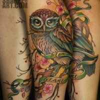 Beautiful colored accurate owl tattoo combined with flowers and lettering