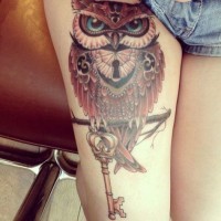 Beautiful colored and detailed big owl shaped lock with antic key tattoo on thigh