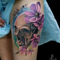 Beautiful colored thigh tattoo of human skull with violet flowers