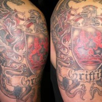 Beautiful colorful family crest with dragon tattoo on half sleeve