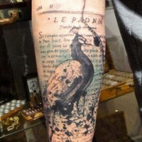 Beautiful combined antic lettering with wonderful bird tattoo on arm