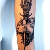 Beautiful dagger pierced head of tiger forearm tattoo