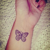 Beautiful gray ink butterfly wrist tattoo