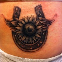 Beautiful horseshoe with flower tattoo on stomach