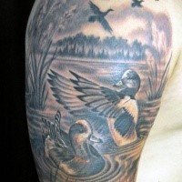 Beautiful illustrative style colored wild ducks tattoo on shoulder