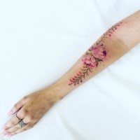 Beautiful looking colored arm tattoo of large flower