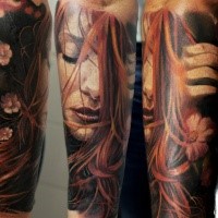 Beautiful looking colored forearm tattoo of sweet woman with flowers