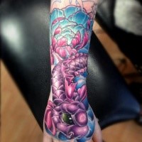 Beautiful looking colored hand tattoo of fantasy fish with flowers