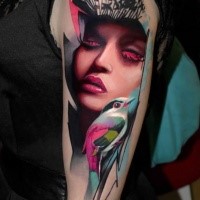 Beautiful looking colored shoulder tattoo of woman face with bird