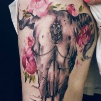 Beautiful looking colored thigh tattoo of mystical animal skull with flowers