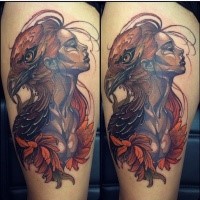 Beautiful looking colored thigh tattoo of woman with eagle head