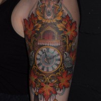 Beautiful looking colorful shoulder tattoo of wall clock stylized with various animals and leaves