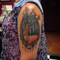 Beautiful natural looking colored deer portrait tattoo on shoulder stylized with berries