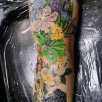 Beautiful natural looking forearm tattoo with flowers