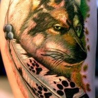 Beautiful painted and colored wolf tattoo with feather