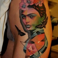 Beautiful painted colored woman with insects tattoo on thigh