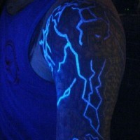 Beautiful painted glowing ink lightning tattoo on arm