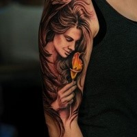 Beautiful painted illustrative style colored shoulder tattoo of woman with flower