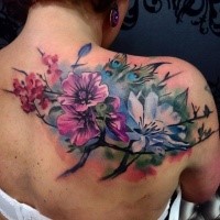 Beautiful realistic looking colored upper back tattoo of various flowers and butterflies