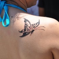 Beautiful simple butterfly tattoo on shoulder