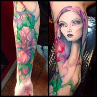 Beautiful watercolor like big flower and woman portrait tattoo on sleeve