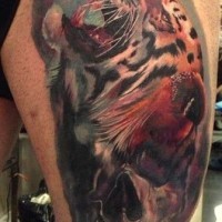 Beautiful watercolor tiger head tattoo on thigh