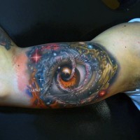 Big 3D like colorful eye in space tattoo on arm