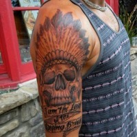 Big American native black ink Indian skull tattoo on shoulder with lettering