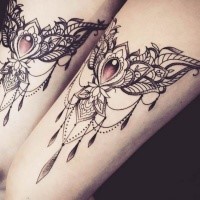 Big beautiful jewelry shaped upper arm tattoo by Caro Voodoo