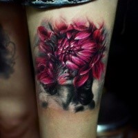 Big beautiful looking colored flower with thigh tattoo of woman portrait
