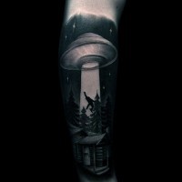 Big black and white alien ship with human and house tattoo on arm