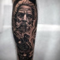Big black and white antic statue with monster tattoo on leg