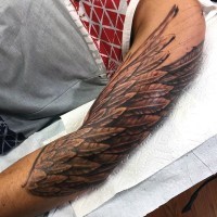 Big black and white detailed wing tattoo on sleeve