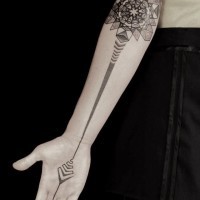 Big black and white flower stylized with mystical ornaments tattoo on arm