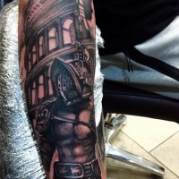 Big black and white forearm tattoo of antic gladiator warrior near roman arena