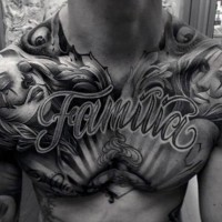 Big black and white lettering with seductive women tattoo on chest