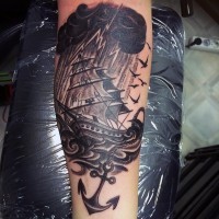 Big black and white nautical ship with anchor and lightning tattoo on arm
