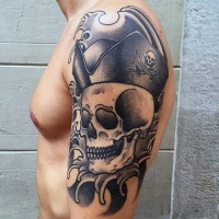 Big black and white pirate skull in hat tattoo on shoulder area