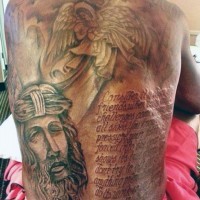 Big black and white religious tattoo with Jesus, angel and lettering on whole back