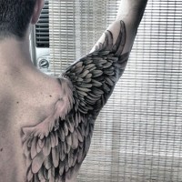 Big black and white wing on shoulder tattoo