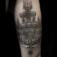 BIg black ink arm tattoo of big demonic candles with skulls