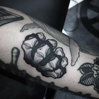 Big black ink arm tattoo of monster wist with knuckles